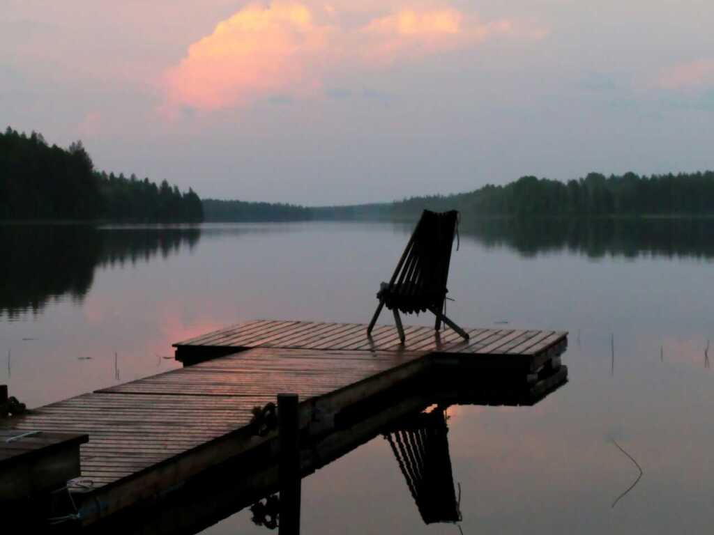 a single empty chair sitting on a dock