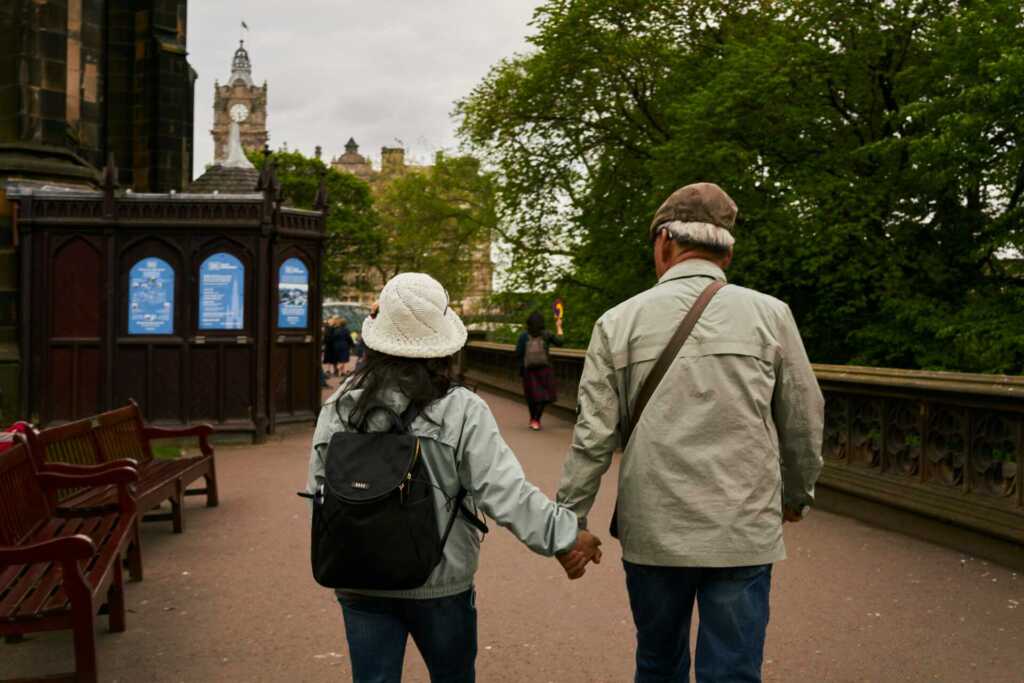 an older couple walking and holding hands