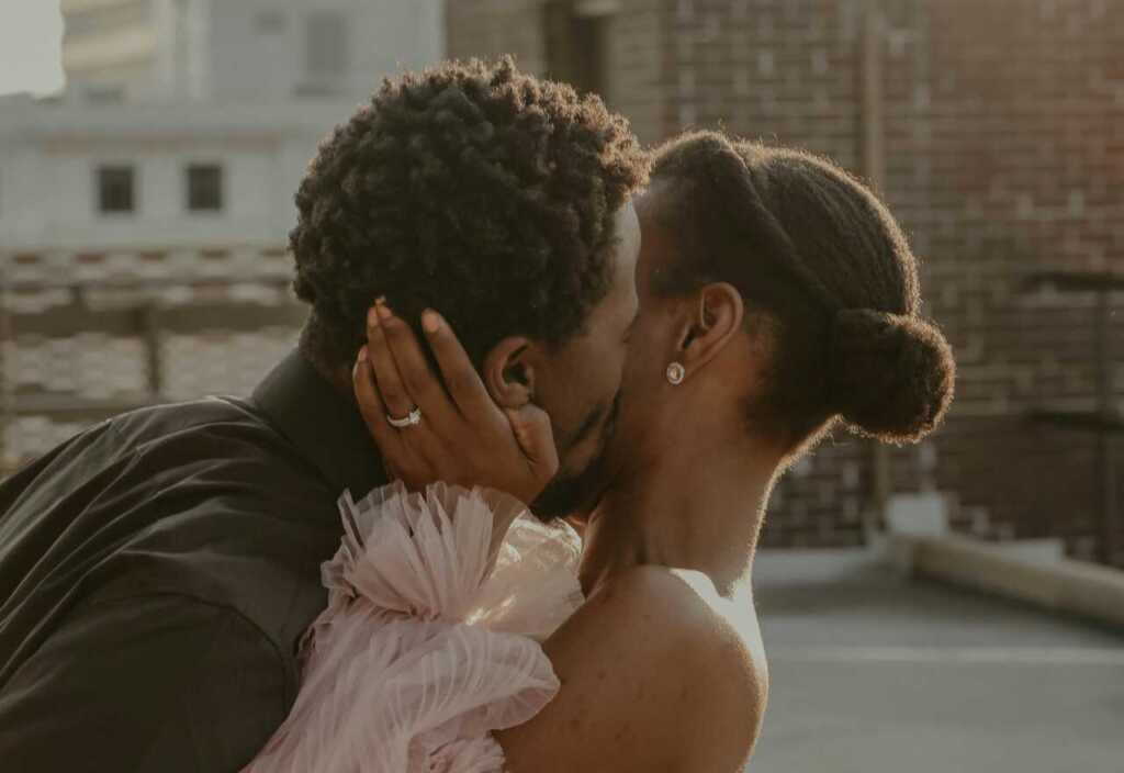 An engaged couple sharing a kiss