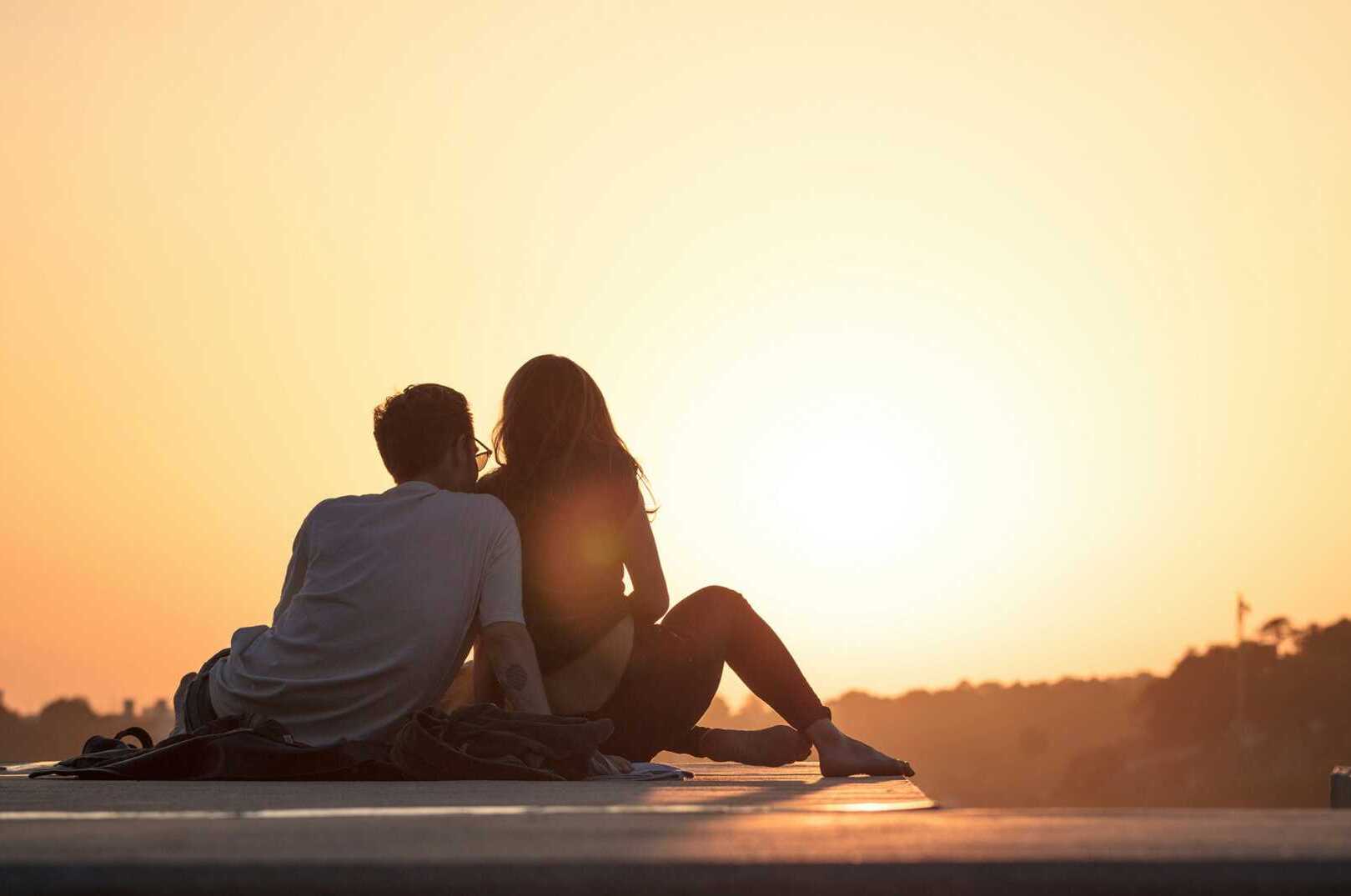 khamkeo OcxlTBbb6SY unsplash A couple leaning against each other looking at the sunset