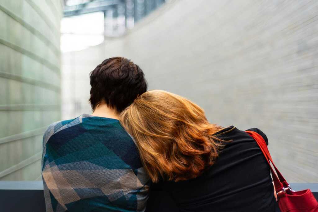 A women leaning her head against her partner's shoulder