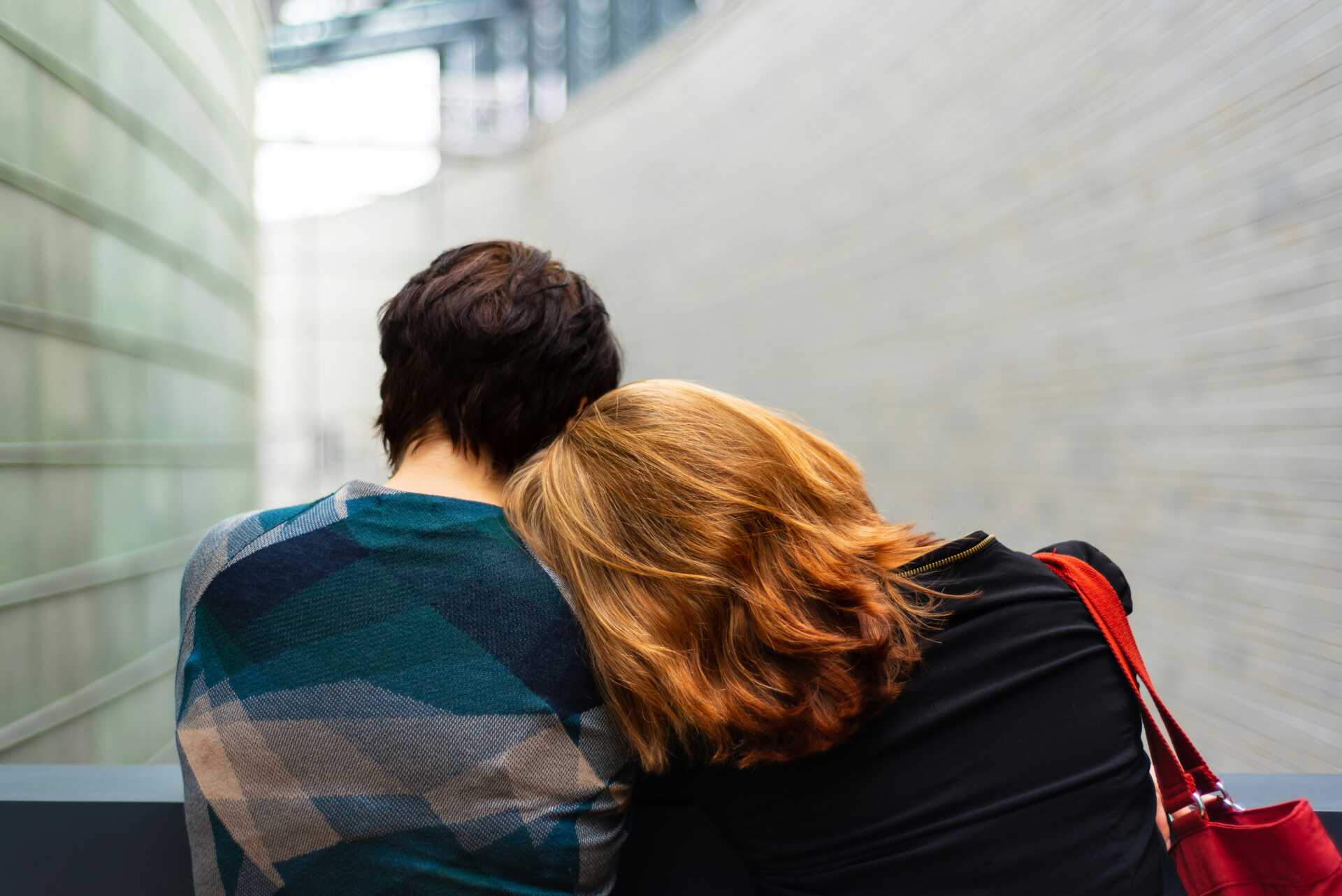 A women leaning her head against her partner's shoulder