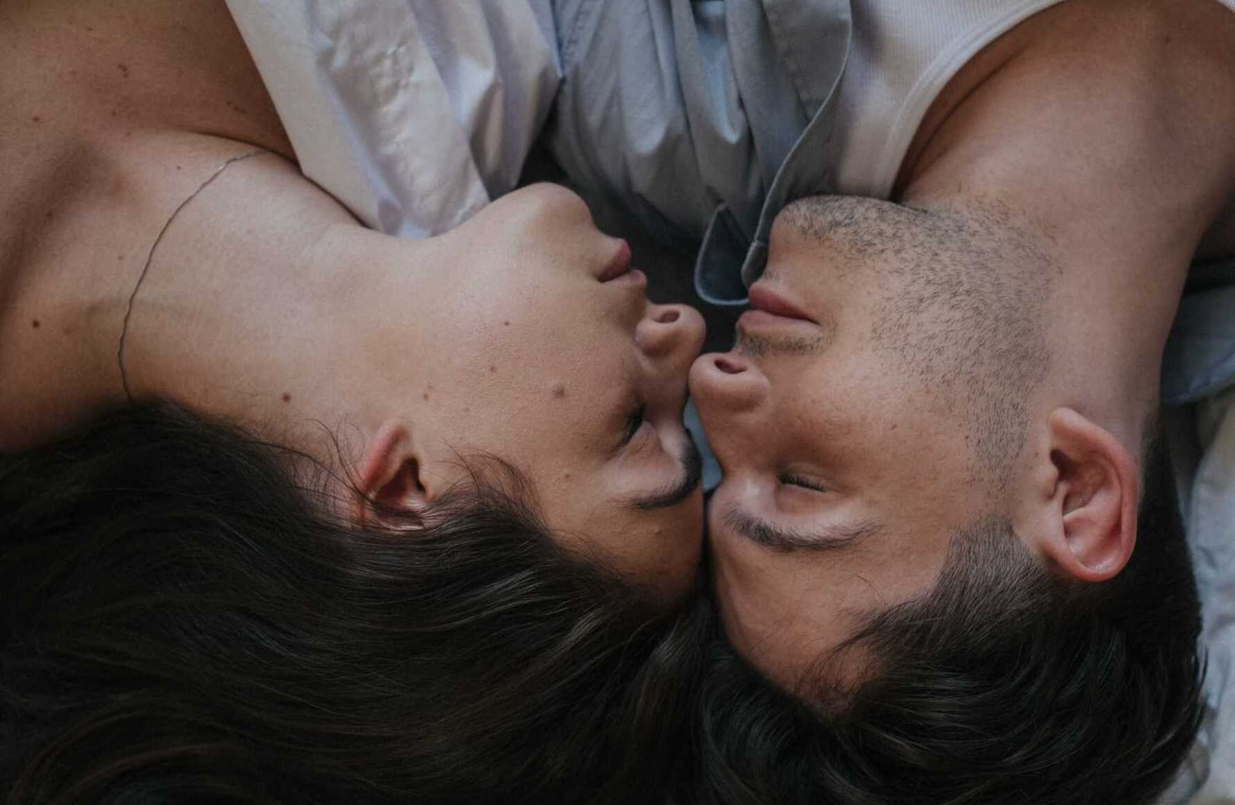 pexels ron lach 9497913 A couple laying down with this eyes closed facing each other