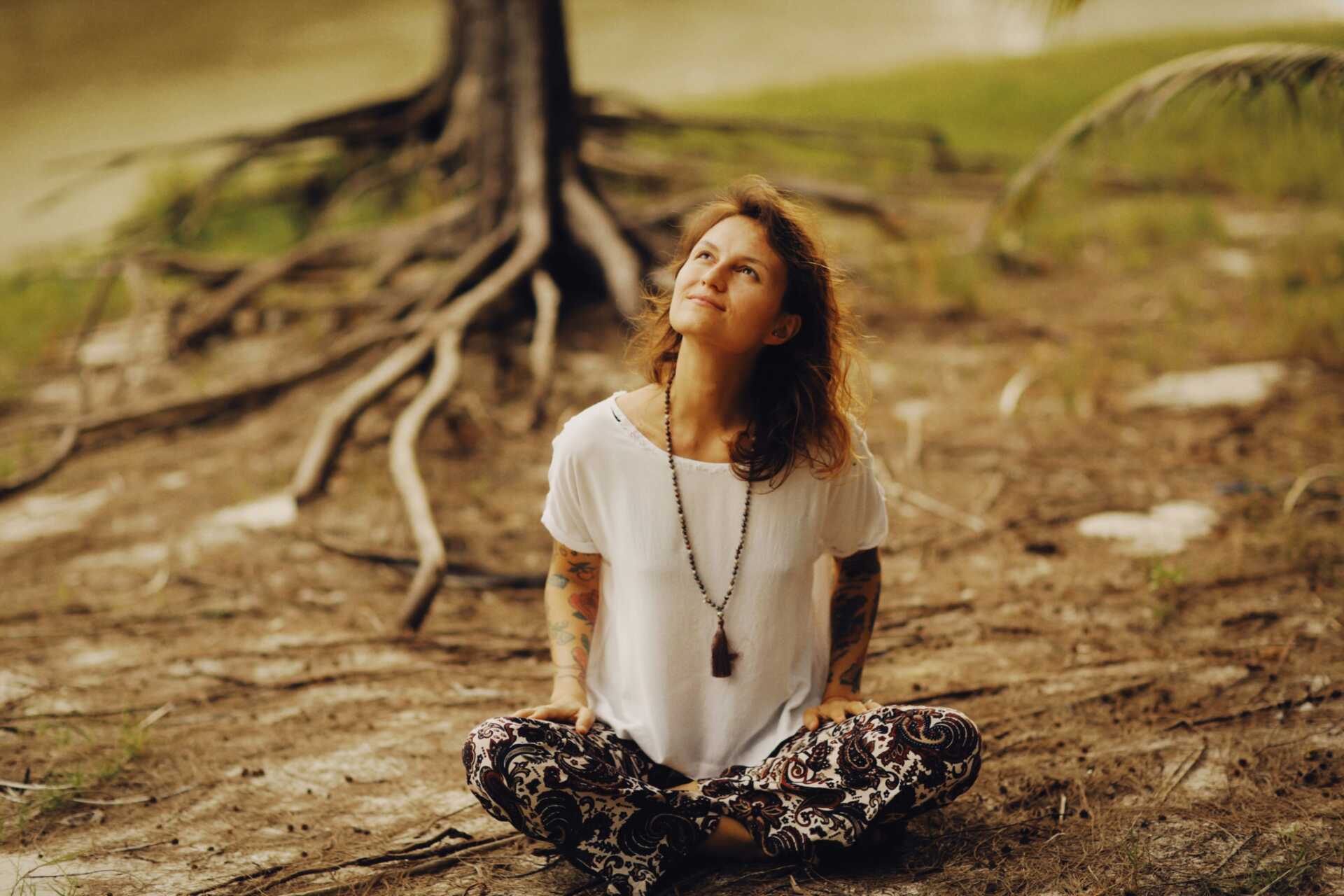 alexey demidov xuoKwH1jHm4 unsplash A woman sitting cross-legged and looking up