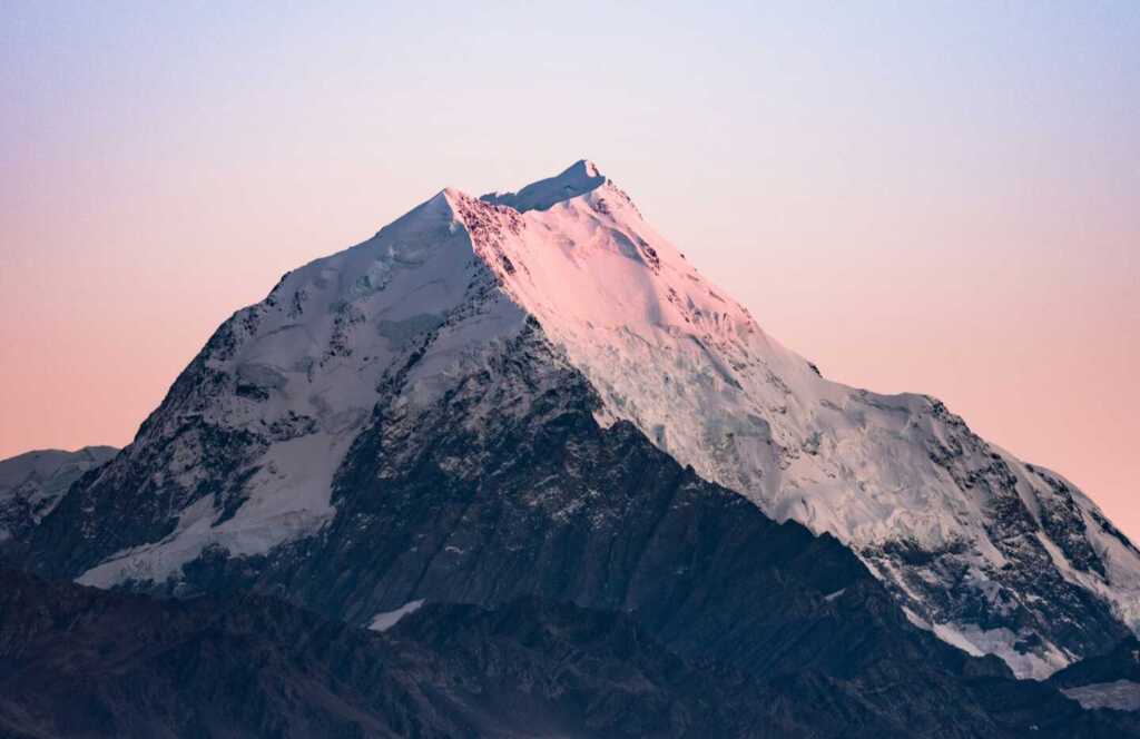 A snow-peaked mountain during a sunrise