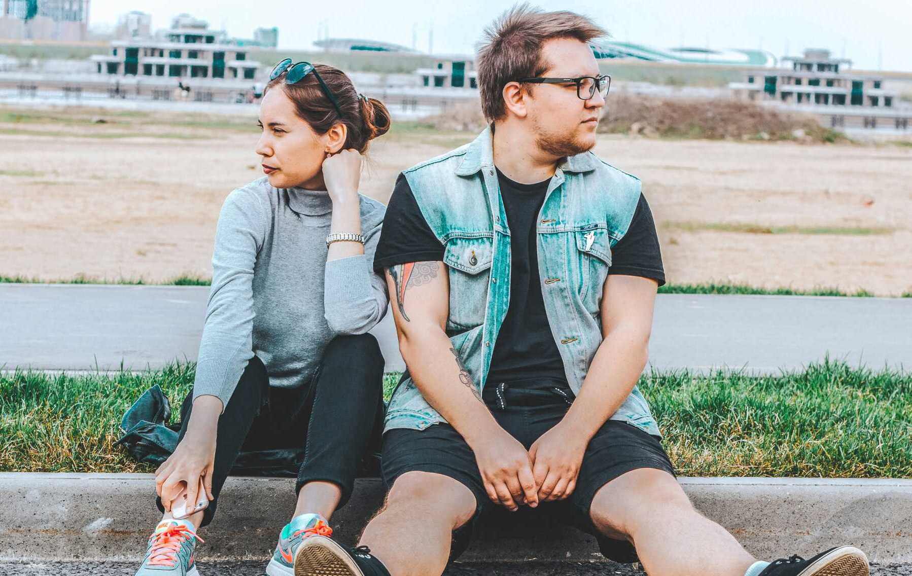 timur m 7zXv5Wk8oWk unsplash A couple sitting outside looking away from each other