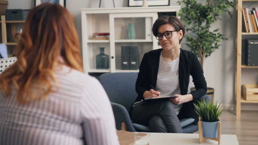 A therapist sitting across from a client