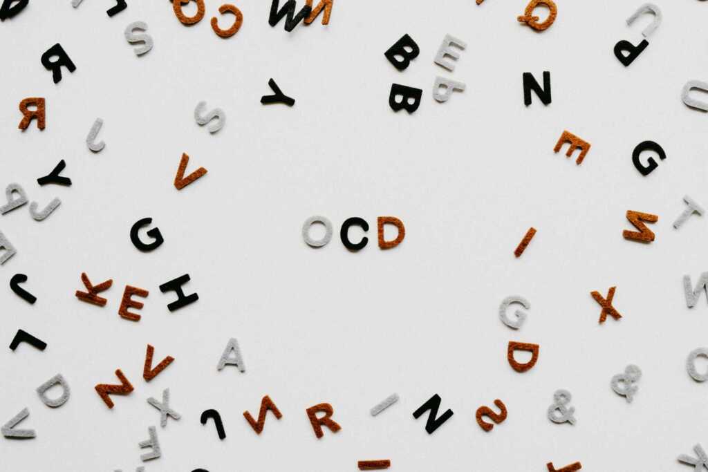 An array of tiled letters with "OCD" in the middle