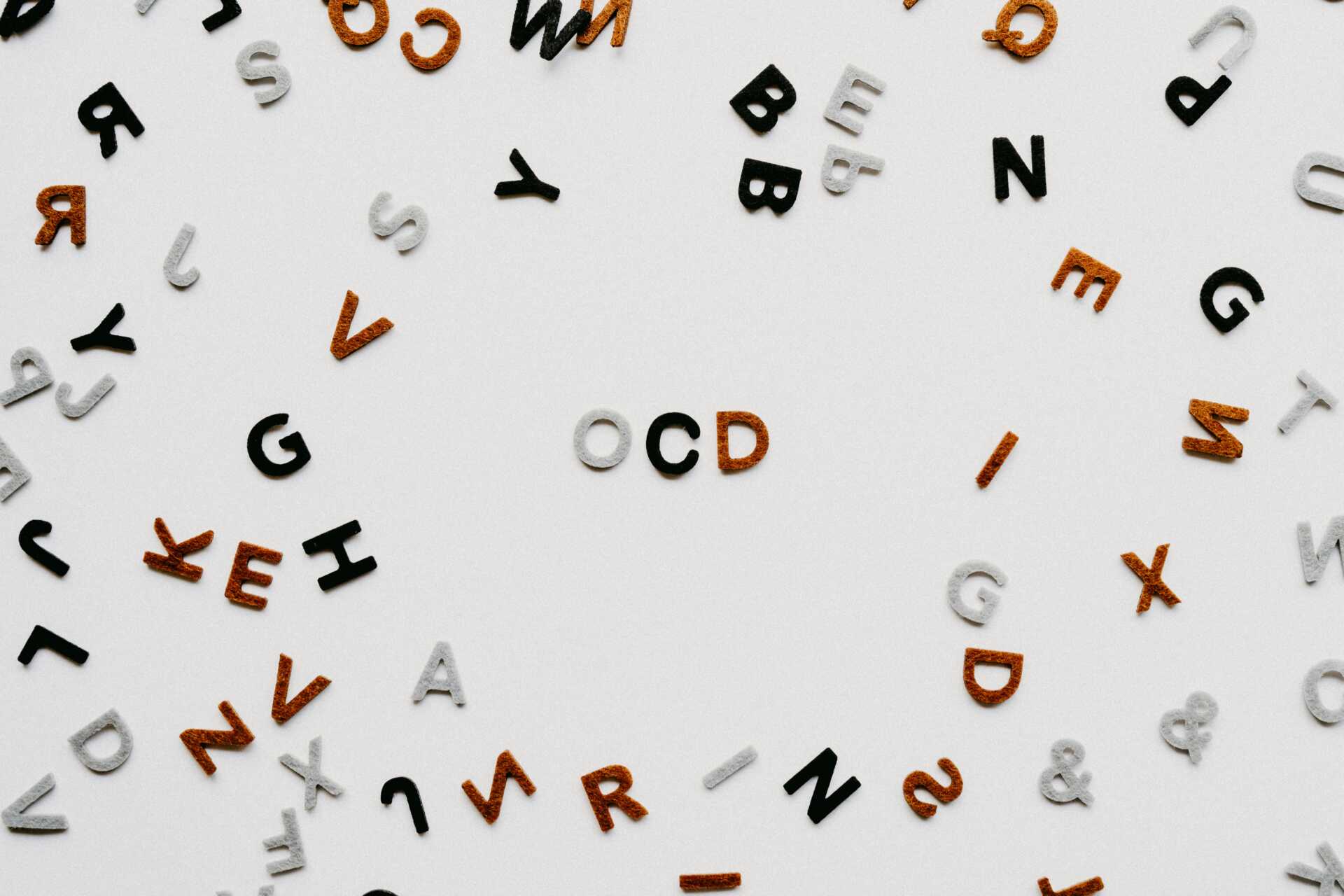 annie spratt 4BwcmbExs5c unsplash An array of tiled letters with "OCD" in the middle